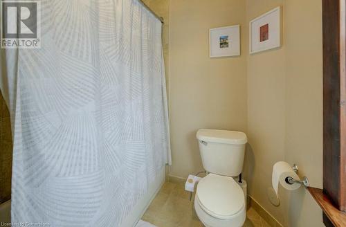 Bathroom with tile patterned flooring, shower / bath combination with curtain, and toilet - 97 Peppler Street, Waterloo, ON - Indoor Photo Showing Bathroom