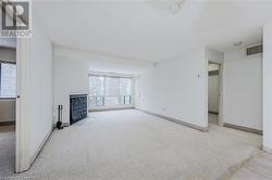 Unfurnished living room featuring light colored carpet and a wealth of natural light - 