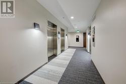 Corridor with elevator and dark colored carpet - 