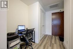 Office with light wood-type flooring - 