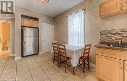 Dining space with light tile patterned floors and sink - 