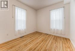 Spare room featuring light wood-type flooring and a wealth of natural light - 