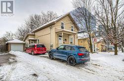 View of front of home with a garage and an outdoor structure - 