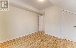 Bonus room featuring light wood-type flooring and vaulted ceiling - 