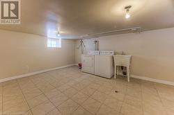 Laundry room with sink and washing machine and clothes dryer - 