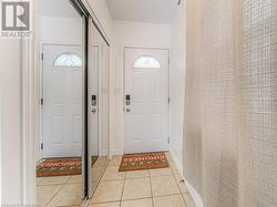 Foyer entrance featuring light tile patterned floors - 