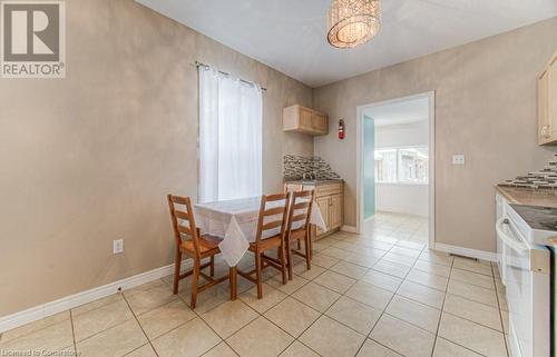 Tiled dining area featuring sink and a chandelier - 67 Wellington Street N, Kitchener, ON - Indoor