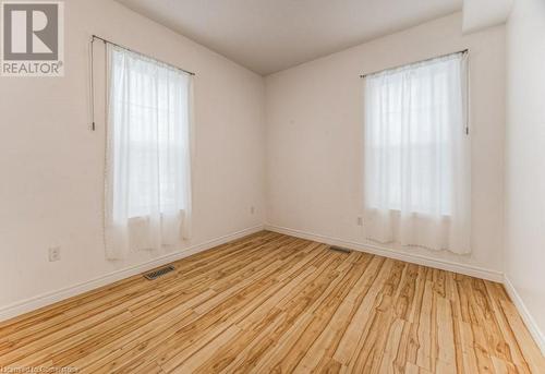 Spare room with light hardwood / wood-style floors and a healthy amount of sunlight - 67 Wellington Street N, Kitchener, ON - Indoor Photo Showing Other Room