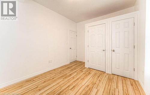 Unfurnished bedroom with light wood-type flooring - 67 Wellington Street N, Kitchener, ON - Indoor Photo Showing Other Room