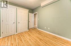 Unfurnished bedroom with light wood-type flooring - 