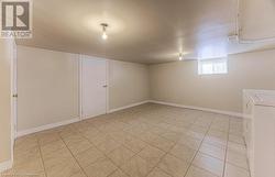 Basement featuring light tile patterned flooring - 