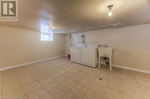 Clothes washing area with washer and clothes dryer and sink - 67 Wellington Street N, Kitchener, ON - Indoor Photo Showing Laundry Room