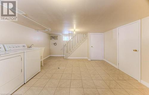 Washroom featuring light tile patterned floors and washer and dryer - 67 Wellington Street N, Kitchener, ON - Indoor Photo Showing Laundry Room