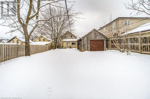 Snowy yard featuring an outbuilding and a garage - 67 Wellington Street N, Kitchener, ON - Outdoor