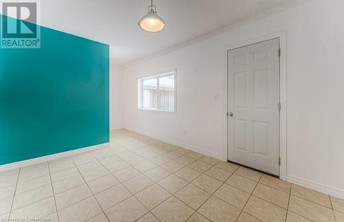 Spare room with light tile patterned floors and ornamental molding - 67 Wellington Street N, Kitchener, ON - Indoor Photo Showing Other Room