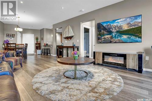 303 1715 Badham Boulevard, Regina, SK - Indoor Photo Showing Living Room With Fireplace