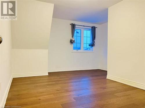 Empty room featuring hardwood / wood-style flooring - 255 Woolwich Street Unit# 203, Waterloo, ON - Indoor Photo Showing Other Room