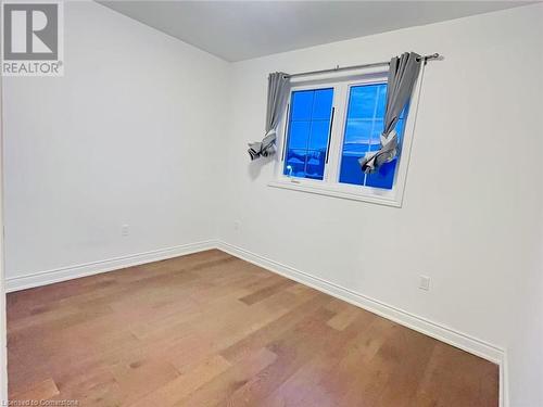 Spare room featuring hardwood / wood-style flooring - 255 Woolwich Street Unit# 203, Waterloo, ON - Indoor Photo Showing Other Room