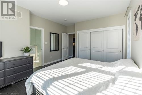 Bedroom featuring dark wood-type flooring, ensuite bath, and a closet - 219 Falconridge Drive, Kitchener, ON - Indoor Photo Showing Bedroom