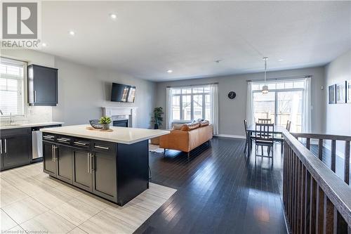 Kitchen with decorative light fixtures, dishwasher, sink, backsplash, and a center island - 219 Falconridge Drive, Kitchener, ON - Indoor