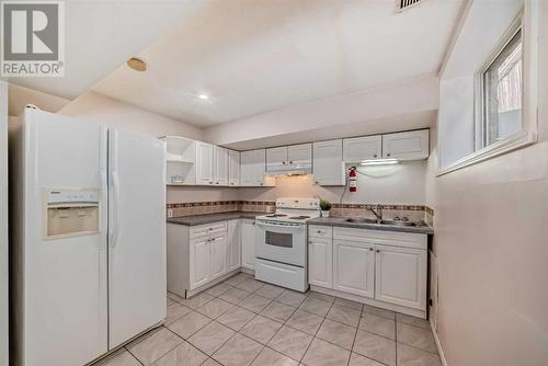 1059 Abbeydale Drive Ne, Calgary, AB - Indoor Photo Showing Kitchen With Double Sink