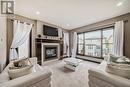 181 Everoak Circle Sw, Calgary, AB  - Indoor Photo Showing Living Room With Fireplace 