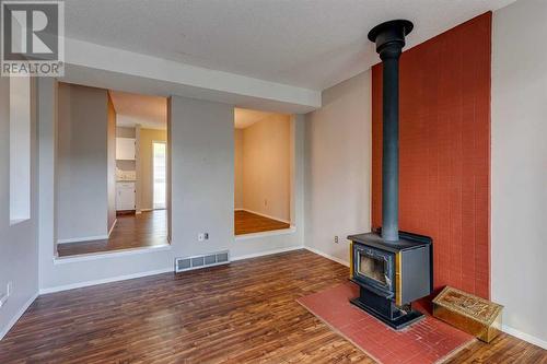 703, 120 Silvercreek Close Nw, Calgary, AB - Indoor Photo Showing Other Room With Fireplace