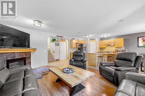 209 Tuscany Ravine Road Nw, Calgary, AB - Indoor Photo Showing Living Room With Fireplace