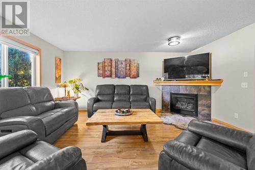 209 Tuscany Ravine Road Nw, Calgary, AB - Indoor Photo Showing Living Room With Fireplace