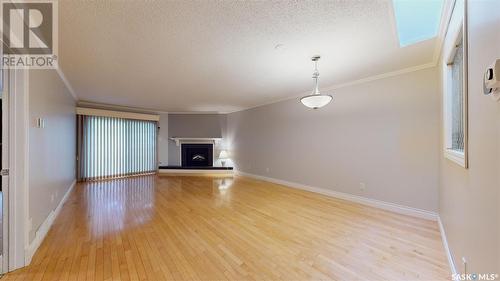 1204 Gryphons Walk, Regina, SK - Indoor Photo Showing Living Room With Fireplace