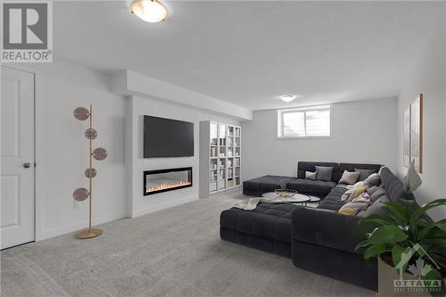 Lower Level Family Room virtually staged - 995 Acoustic Way, Ottawa, ON - Indoor With Fireplace