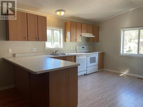 8 2963 Klahannie Drive, Fort Nelson, BC - Indoor Photo Showing Kitchen With Double Sink