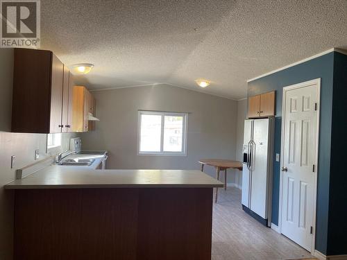 8 2963 Klahannie Drive, Fort Nelson, BC - Indoor Photo Showing Kitchen With Double Sink