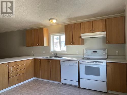 8 2963 Klahannie Drive, Fort Nelson, BC - Indoor Photo Showing Kitchen With Double Sink