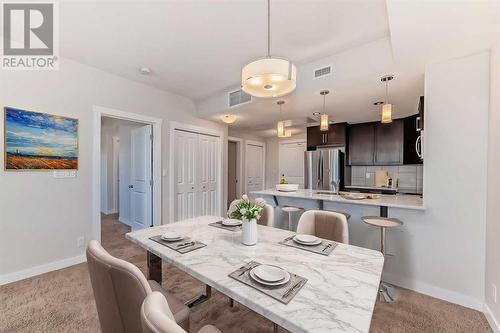 Dining Room Virtually Staged - 906, 32 Varsity Estates Circle Nw, Calgary, AB - Indoor Photo Showing Dining Room