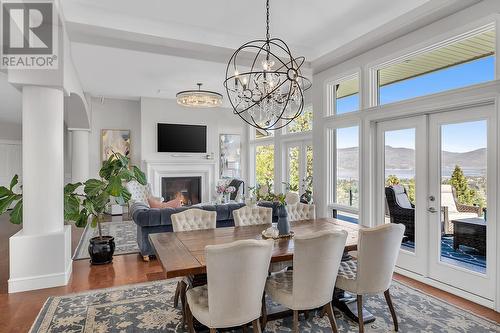 4822 Carmel Crescent, Kelowna, BC - Indoor Photo Showing Dining Room With Fireplace