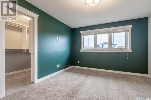 5114 Anthony Way, Regina, SK - Indoor Photo Showing Other Room With Fireplace