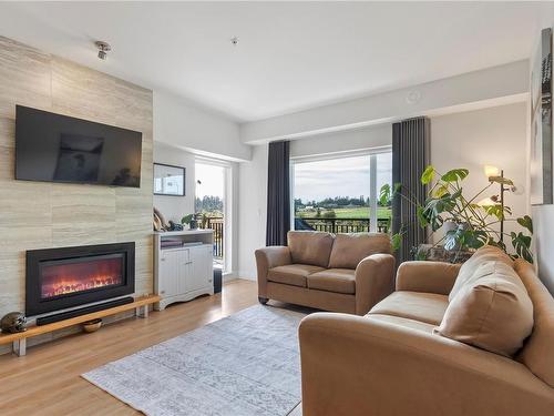 302-2500 Hackett Cres, Central Saanich, BC - Indoor Photo Showing Living Room With Fireplace