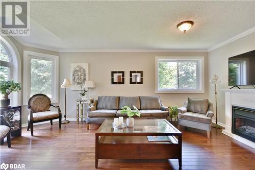 Stunning hardwood in open concept living room! - 165 Cheltenham Road, Barrie, ON - Indoor Photo Showing Living Room With Fireplace