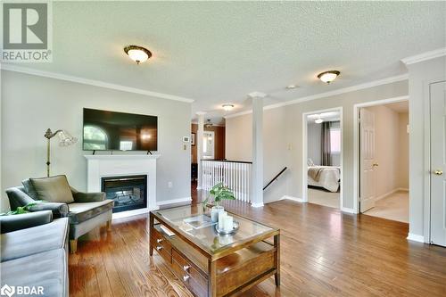 Open concept living room with stunning hardwood! - 165 Cheltenham Road, Barrie, ON - Indoor Photo Showing Living Room With Fireplace