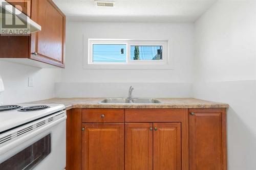 224 Penswood Way Se, Calgary, AB - Indoor Photo Showing Kitchen With Double Sink