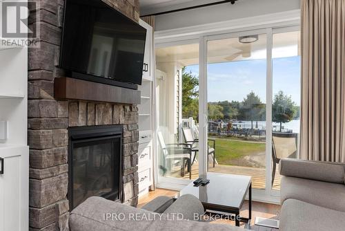 16 - 1869 Highway 118 West, Bracebridge, ON - Indoor Photo Showing Living Room With Fireplace