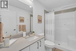 Ensuite with a standing shower and quartz counters. - 