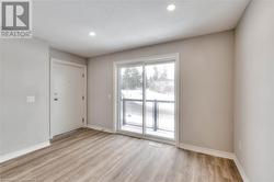 Empty room featuring a textured ceiling and light hardwood / wood-style floors - 