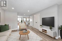 Living room featuring light hardwood / wood-style floors and a textured ceiling - 