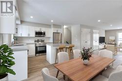 Dining area with sink and light wood-type flooring - 