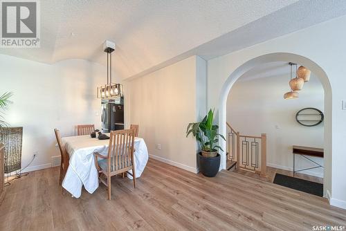 1707 Clive Bay E, Regina, SK - Indoor Photo Showing Dining Room With Fireplace