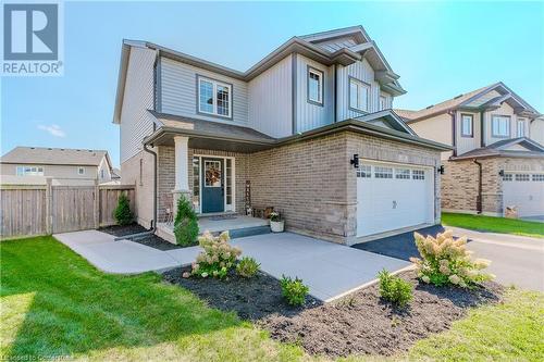 View of front of property featuring a garage and a front yard - 12 Hardcastle Place, Cambridge, ON - Outdoor