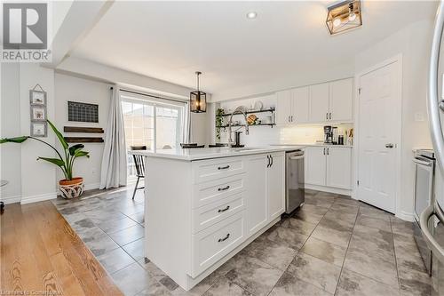 Kitchen featuring sink, stainless steel dishwasher, pendant lighting, a kitchen island with sink, and white cabinets - 12 Hardcastle Place, Cambridge, ON - Indoor Photo Showing Kitchen