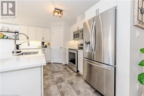 Kitchen featuring white cabinetry, stainless steel appliances, and sink - 12 Hardcastle Place, Cambridge, ON - Indoor Photo Showing Kitchen With Stainless Steel Kitchen